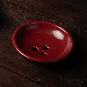 close up of red soap dish