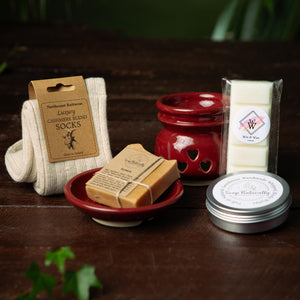 Gift containing luxury cashmere socks, oil burner, wax bar, body butter and tumeric soap