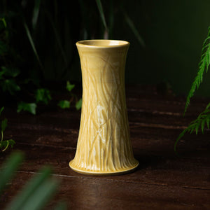 mustard vase in green background