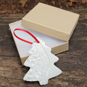 Christmas Tree Decoration in the shape of a Christmas tree in a box and red ribbon