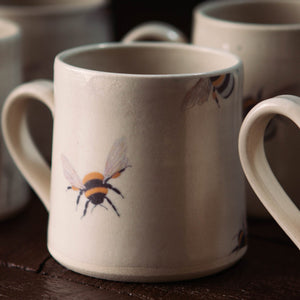 This beautiful stoneware mug was inspired by the Honeybee.  The pottery mug perfectly captures the stunning Honeybee palate, unique golden-yellow and brown bands, and oval-shape body.  