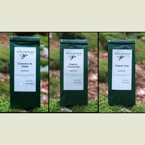 Image of 3 packs of Herbal tea sitting on rock part of herbal tea gift set