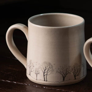 Crafted by hand with hand painted trees and birds complete with a glaze which gives each mug has its own unique character.  